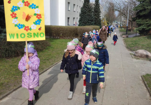 Dzieci i nauczyciele idący na spacer po osiedlu