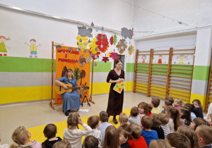 Na scenie pani Agata Skrzypczak grająca na gitarze oraz pani Dominika Kartasińska śpiewająca piosenkę