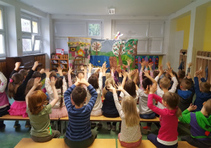 Dzieci unoszą ręce i śpiewają piosenkę razem z wróżką.
