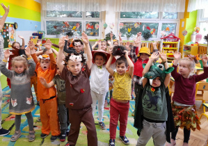 Dzieci z grupy IX z uniesionymi rękami podczas zabawy