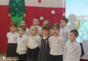 Dzieci z grupy XI na tle biało-czerwonej dekoracji