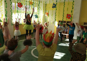 Dzieci z grupy XI naśladują ruchem rąk słoneczka.